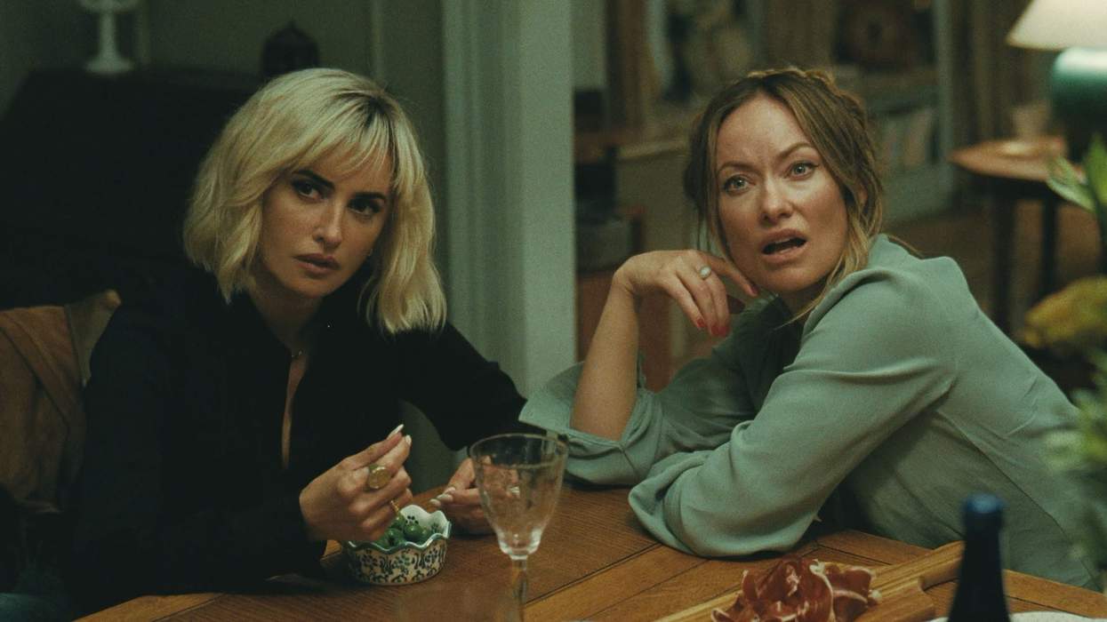 Penelope Cruz and Olivia Wilde sitting at a dinner table in The Invite