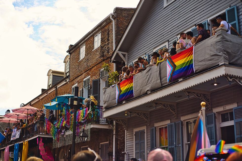 People watch the Southern Decadence parade in the French Quarter from balconies above Bourbon Street in New Orleans