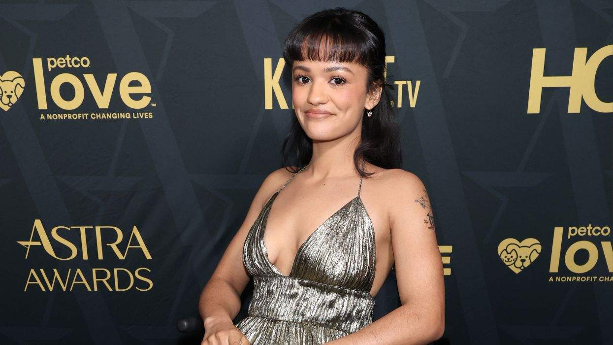 Person at Astra Awards in silver dress, smiling at camera.