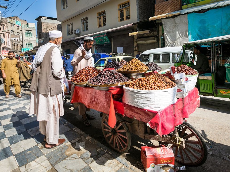 Peshawar Pakistan men in traditional clothes at the street market