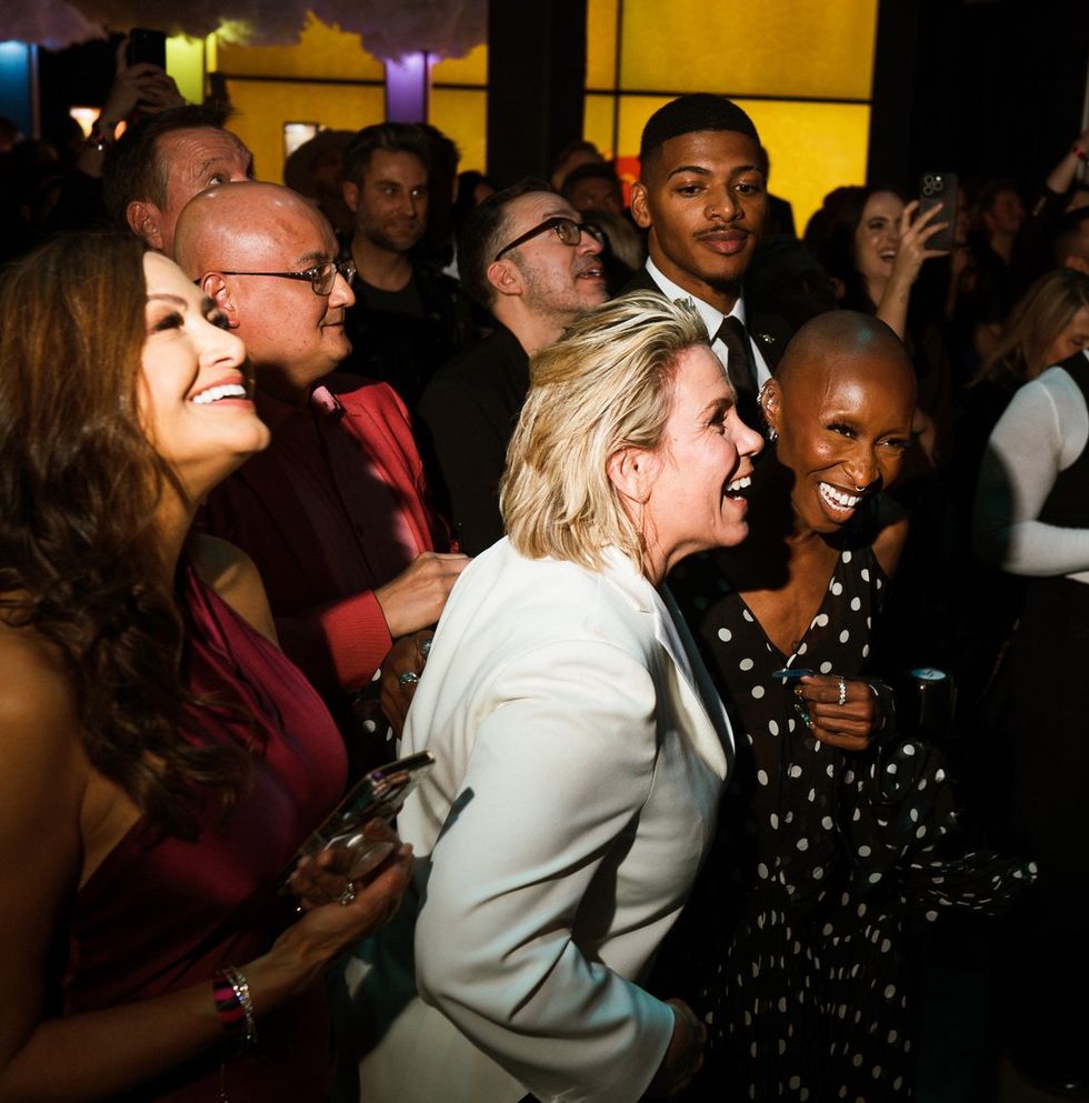 photo gallery queer photographer Roland Fitz Out100 2024 party pics crowd laughing cheering focus on Tracy E Gilchrist Cynthia Erivo