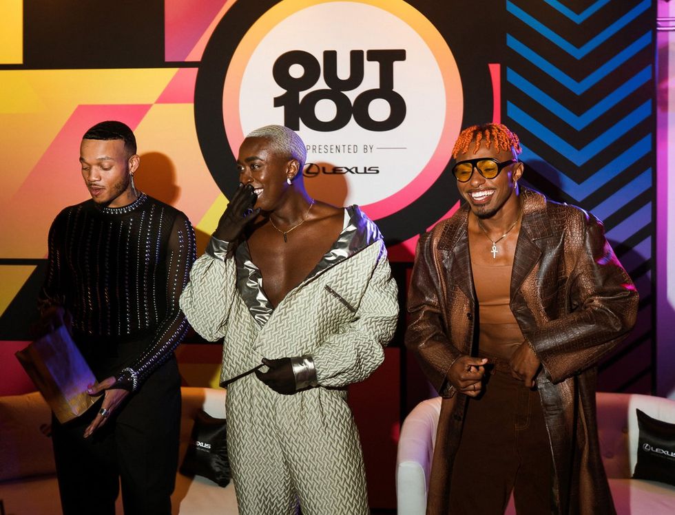 photo gallery queer photographer Roland Fitz Out100 2024 party pics Vincint in the middle with dancers on either side