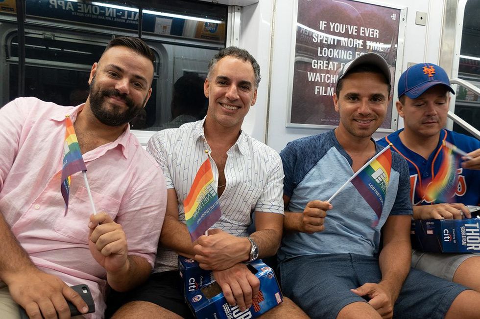 Pride revelers on the subway ride hHome