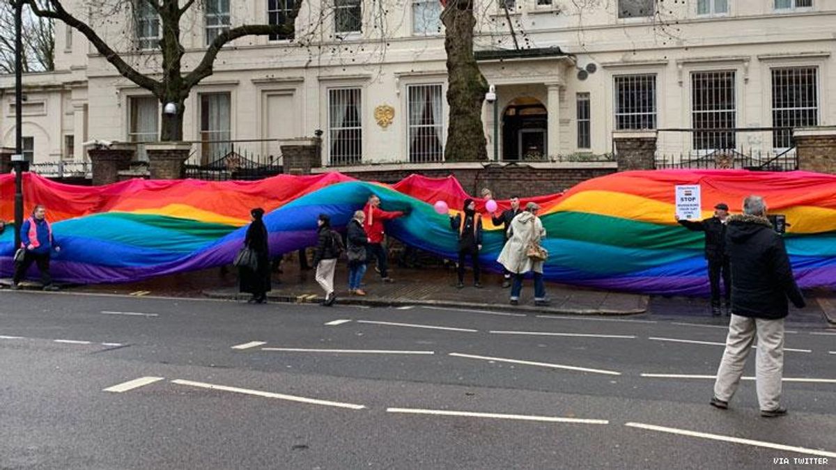 Protesters in London wrap Russian embassy in rainbow flag to help. LGBTQ+ Chechens seeking asylum.
