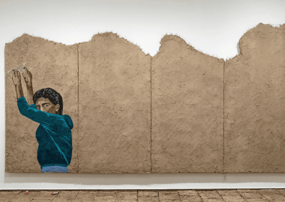 Rafa Esparza\u2019s ...we are the mountain, a large adobe wall installation with an uneven, textured surface.