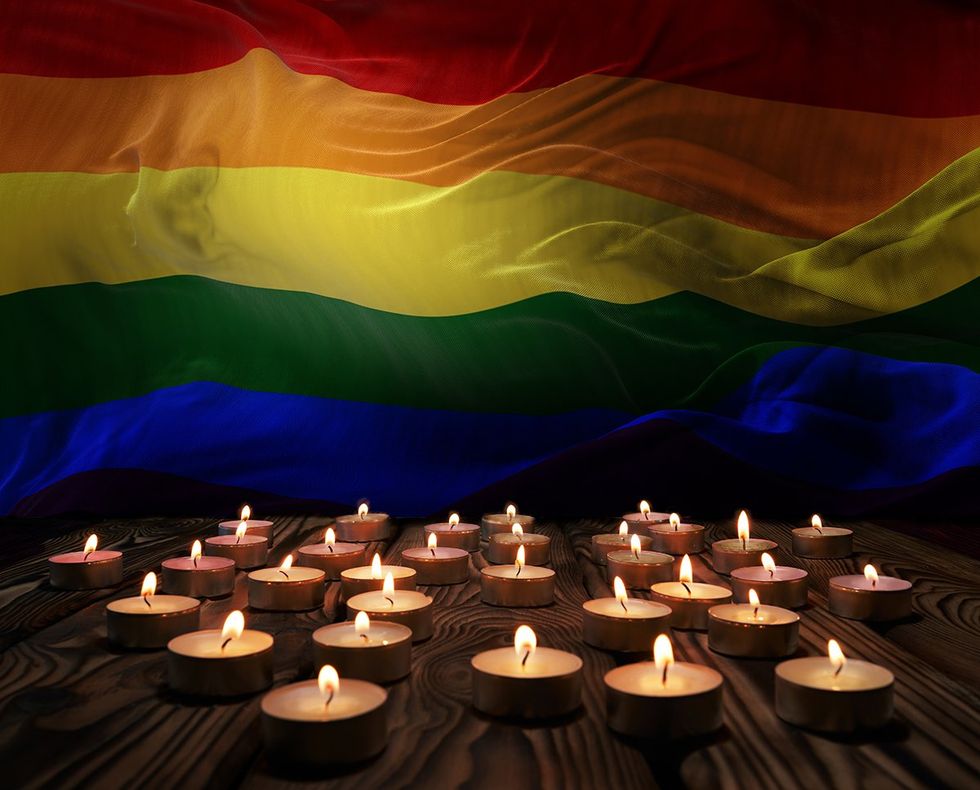 rainbow lgbtq flag with tealight memorial candles