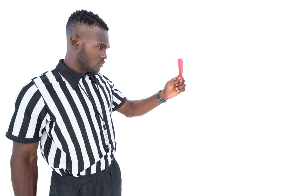 Referee holding a red card