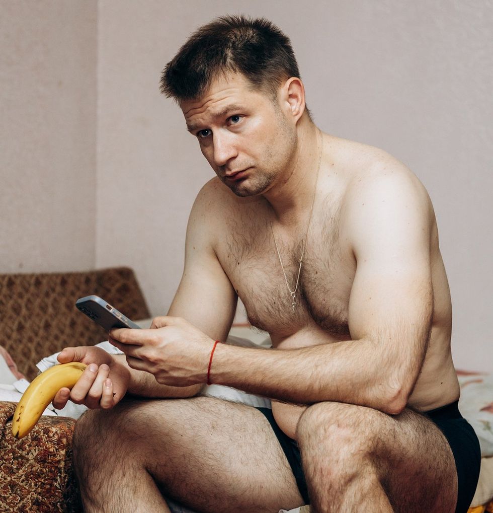 sad man in boxers holding banana and cell phone