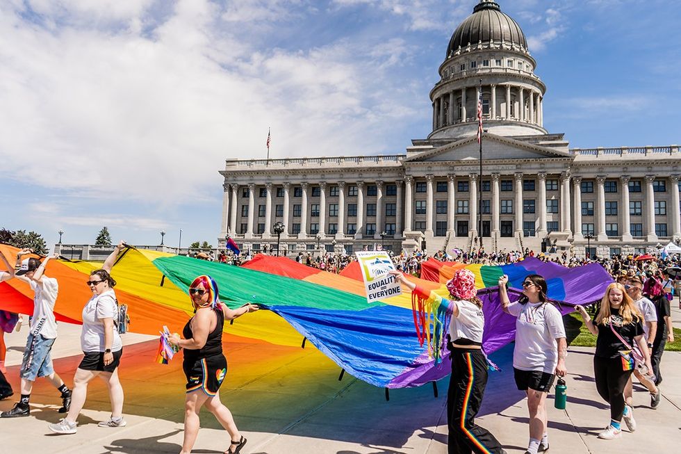 Salt Lake City Utah USA June 1st 2024 Crowd Walking Rainbow Pride Flag Down Capitol Hill SLC Pride Month
