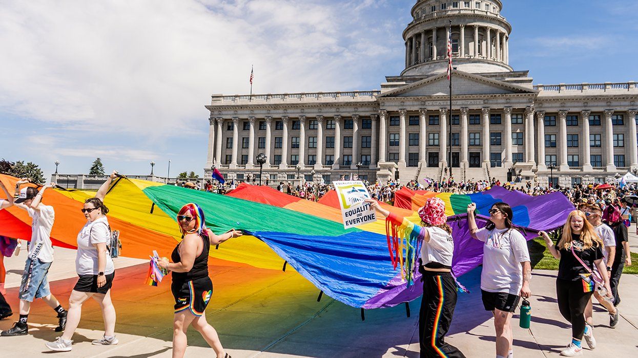 Salt Lake City Utah USA June 2024 Crowd Walking Giant LGBTQIA Rainbow Flag Down Capitol Hill SLC for Pride Month