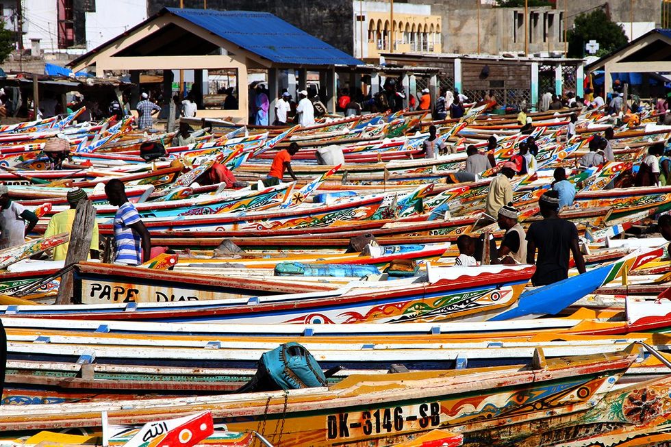 Senegal Soumbedioune fish market in Dakar with typical colourful fishing boats