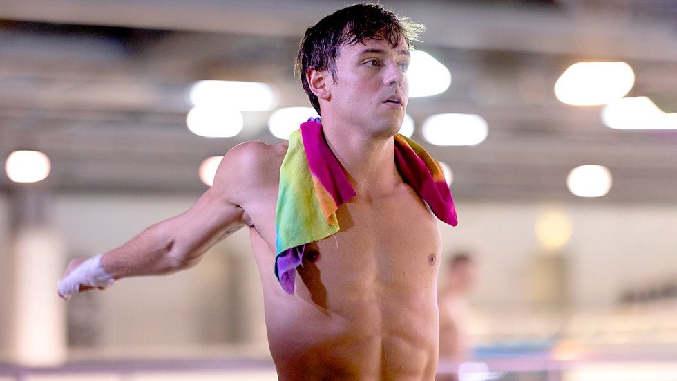 sexy shirtless body gay man olympic diver Tom Daley stretching rainbow lgbtq towel Team GB swimsuits