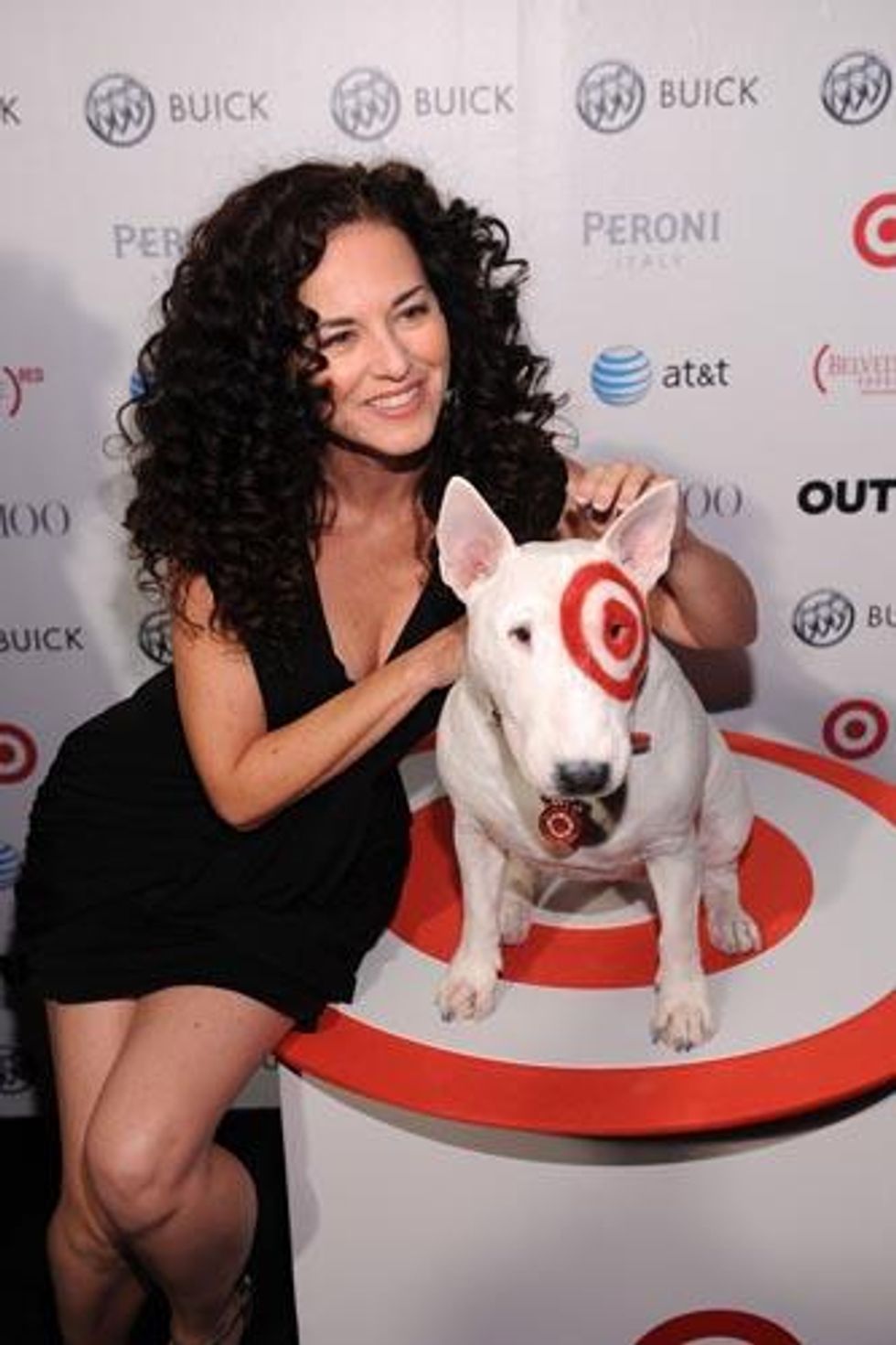 Sherrie Austin poses with the Target dog on her way into the Out100 party