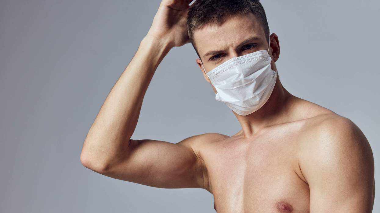 Shirtless man wearing a medical face mask