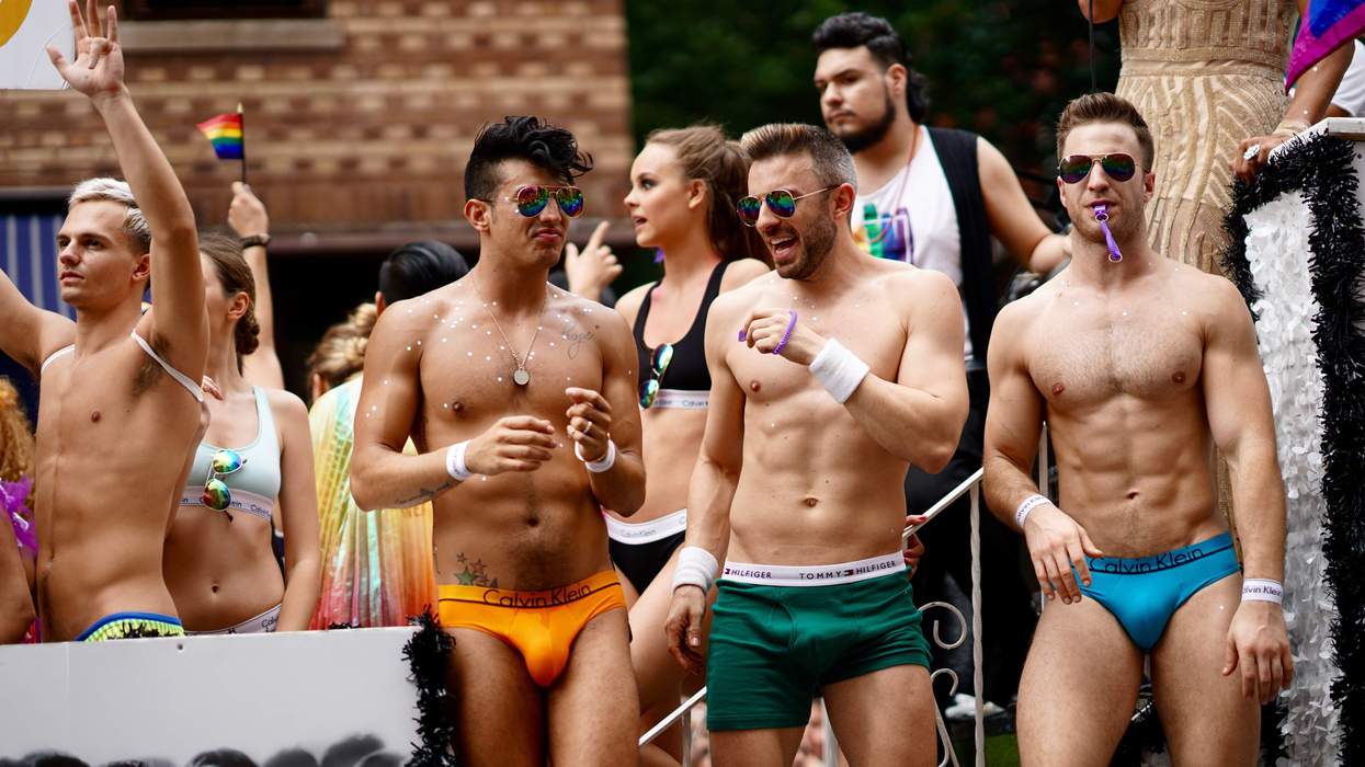 Shirtless Men Cheering in the Gay Pride Parade in NYC.