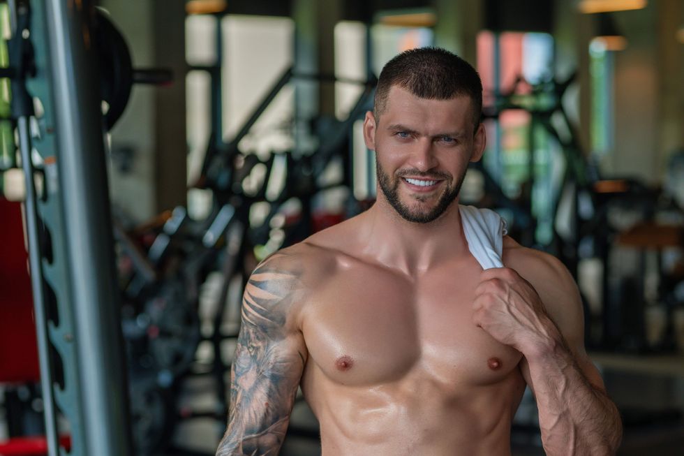 Shirtless muscular man standing in a gym