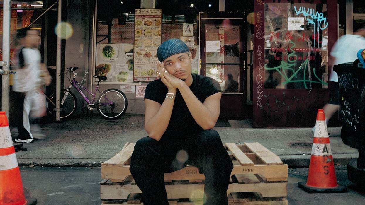 Singer and songwriter Destin Conrad posing for a portrait on the street