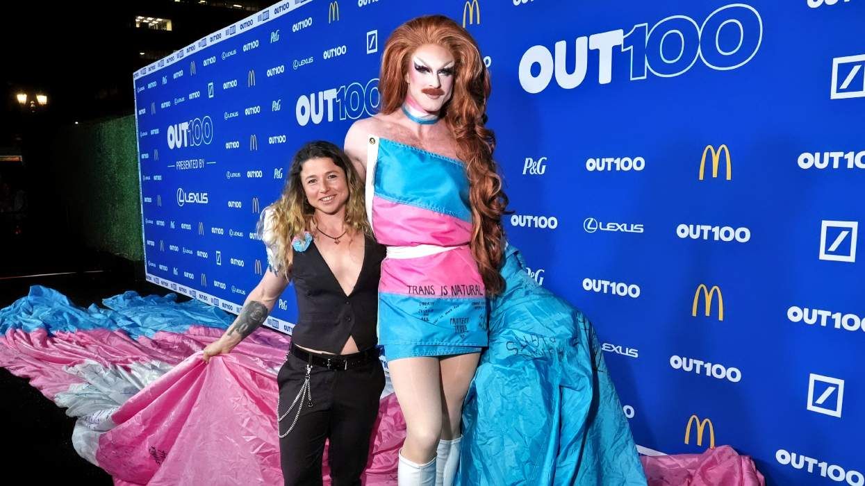 SJ Joslin and Pattie Gonia walk the 2025 Out100 carpet with massive trans pride flag that hung in Yosemite National Park