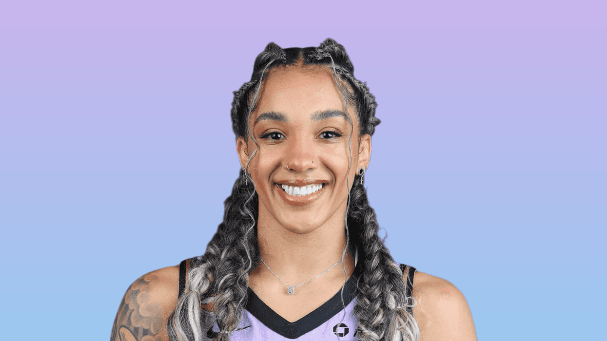 Smiling person with braided hair against a purple gradient background.