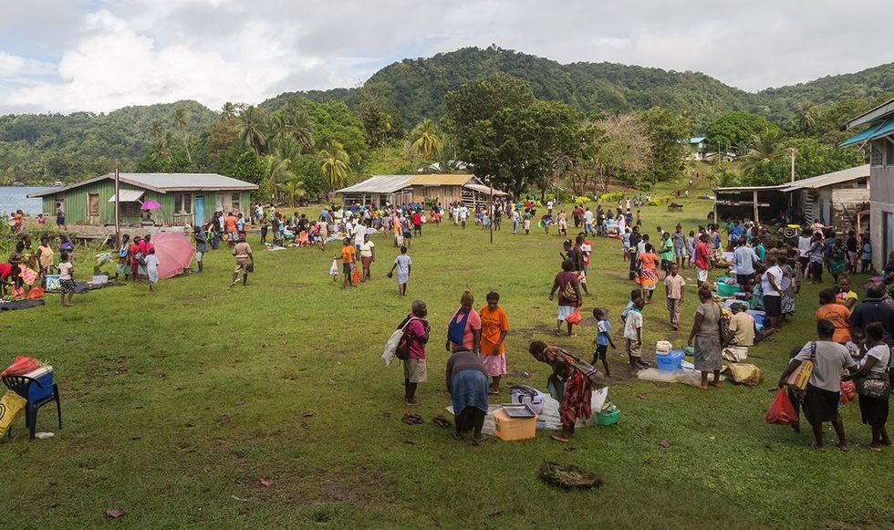 Solomon Islands People buying and selling food at the local market in the village of Batuna