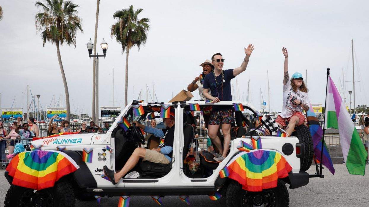 st. petersburg florida pride parade with people in a jeep with rainbow decorations
