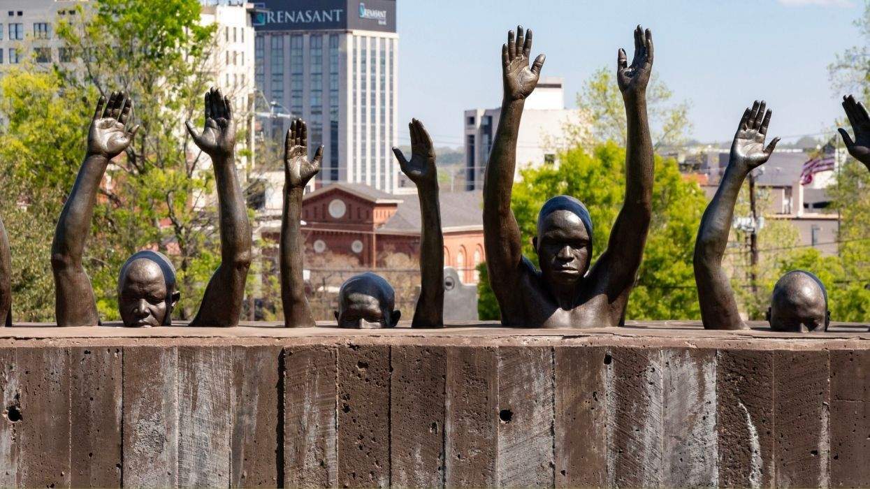 statues with hands raised encased in concrete at the national memorial for peace and justice