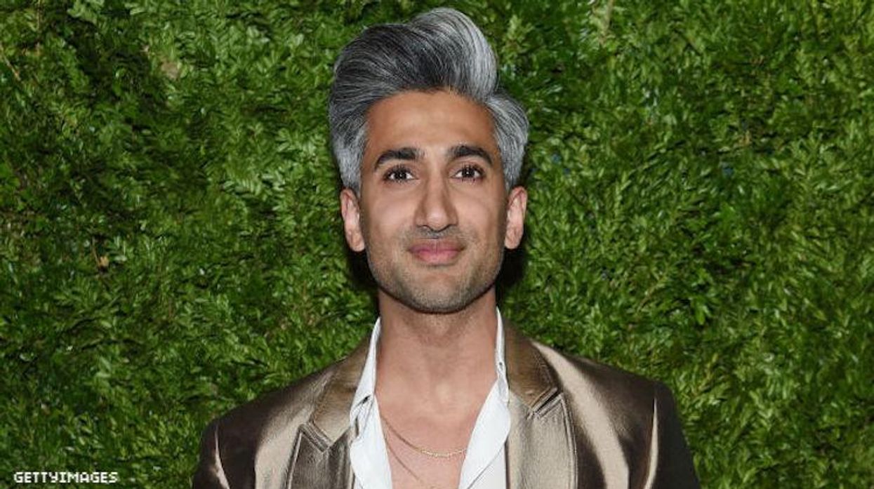 Tan France against a green backdrop.