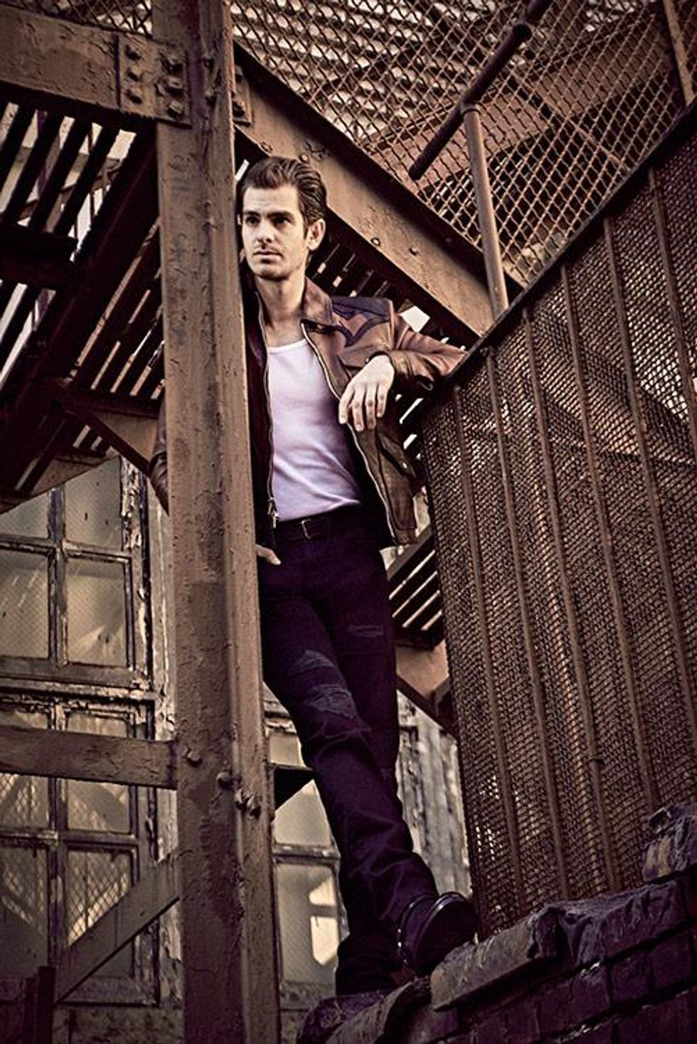 Tank top by Calvin Klein Underwear, jeans by Frame Denim, belt by Saint Laurent, jacket and boots by Coach.