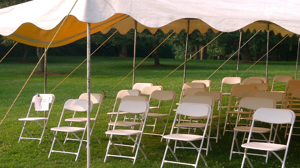 Tent with empty chairs - stock photo