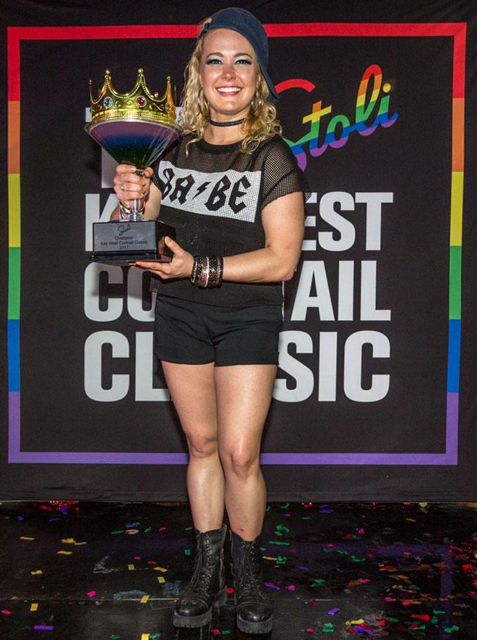 The 2017 Stoli Key West Cocktail Classic Champion Kayla Hasbrook, representing NYC and her home bar ABC Cocina, raises up her trophy.