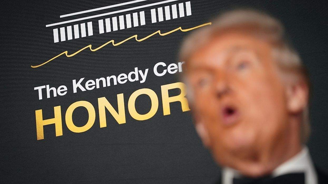 the kennedy center honors step and repeat with a blurry image of donald trump in the foreground