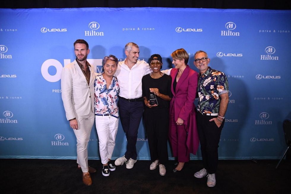 The panel of judges celebrate with OUT Fashion Vanguard winner Kris Harring