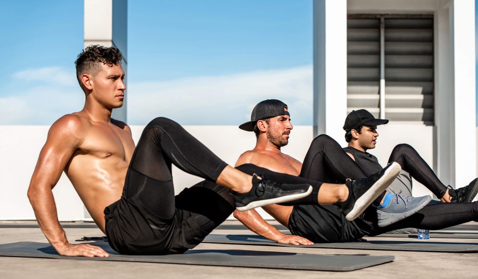 Three men working out on yoga mats