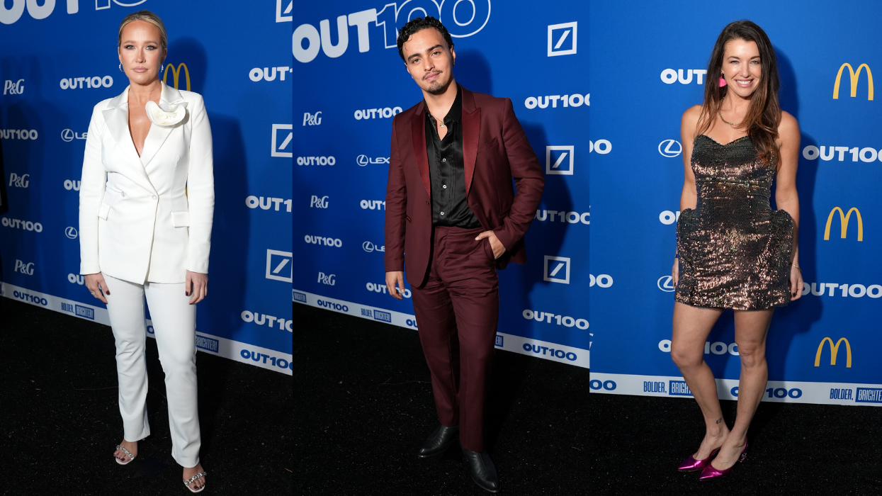 Three people posing on a red carpet