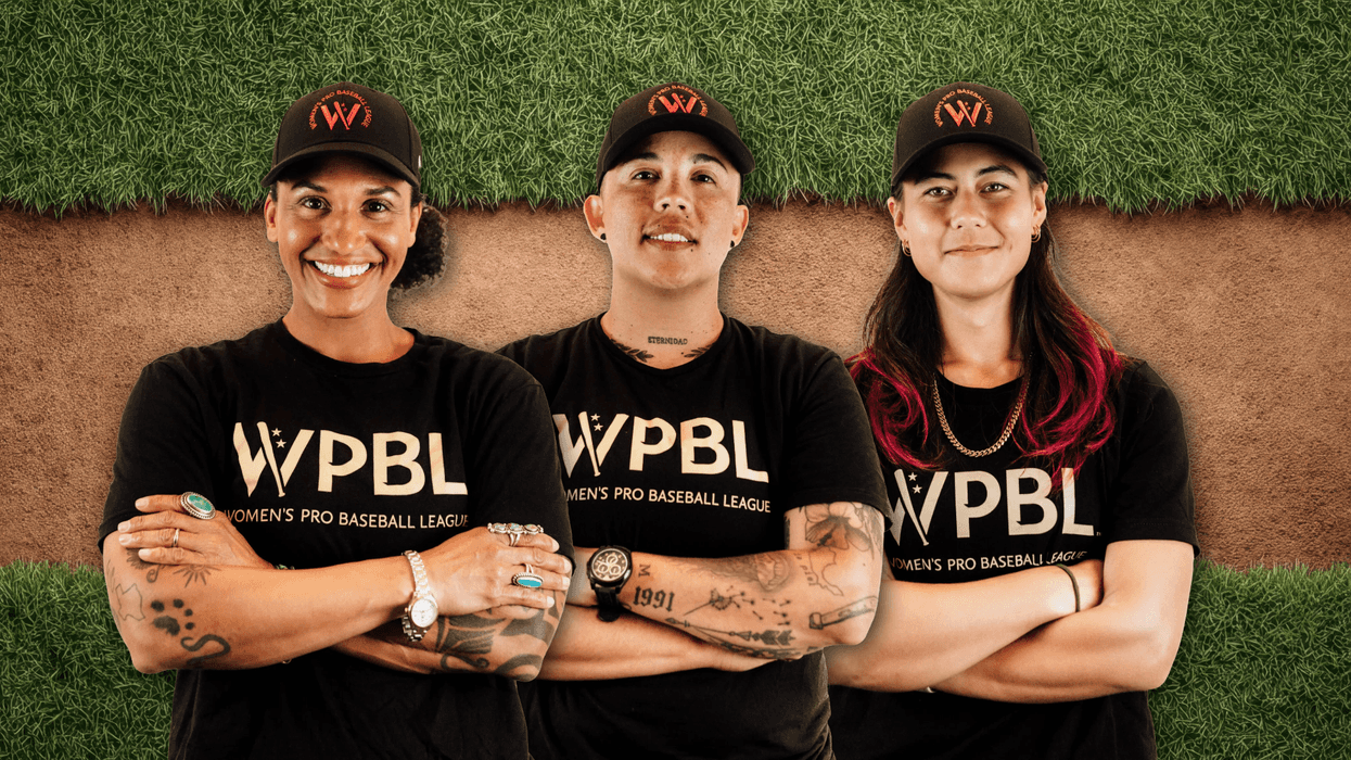 Three people wearing WPBL shirts and caps, standing on a baseball field.