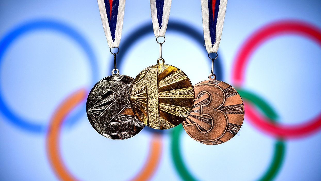 Tokyo 2019 Olympic silver gold bronze medals shown against a soft background with rings logo