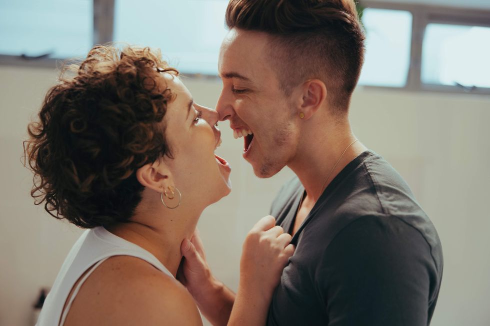 Trans couple laughing and holding each other
