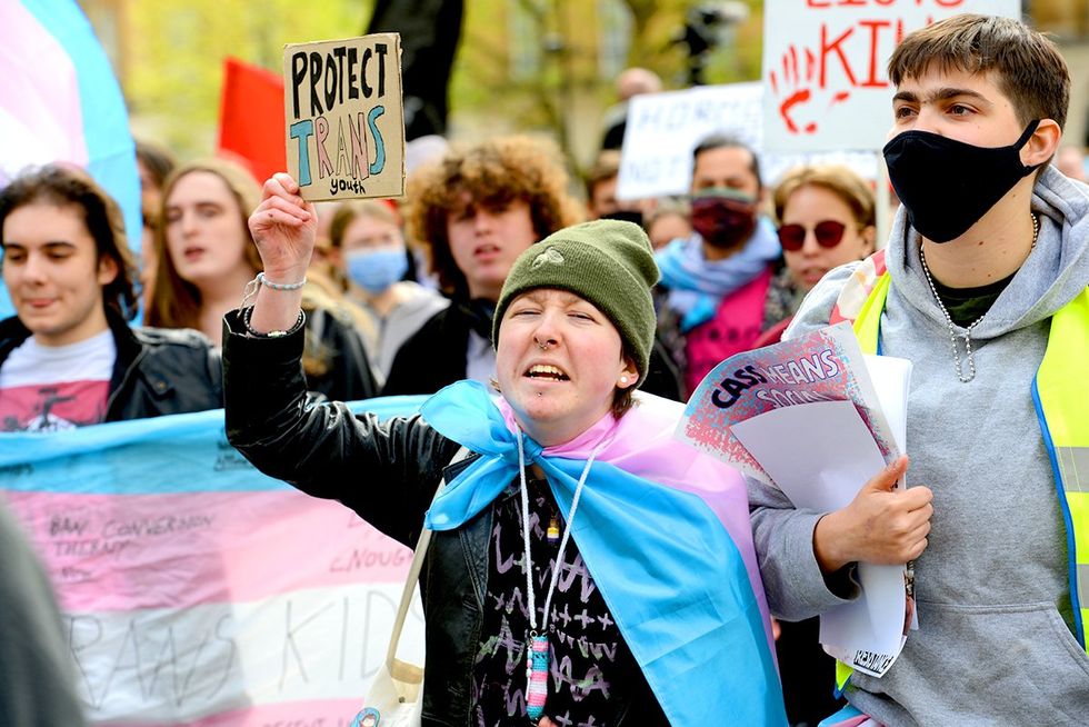 trans healthcare rights march protesters transgender flags