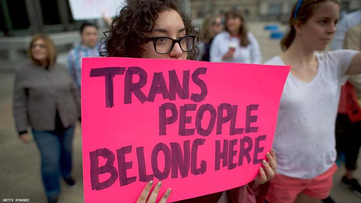 "Trans people belong here" protest sign 