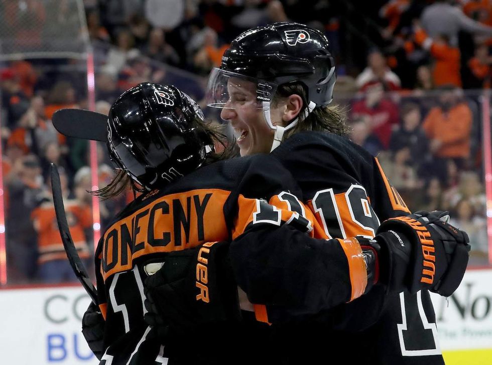 Travis Konecny #11 of the Philadelphia Flyers is congratulated by Nolan Patrick #19 after Konecny scored the game winning goal