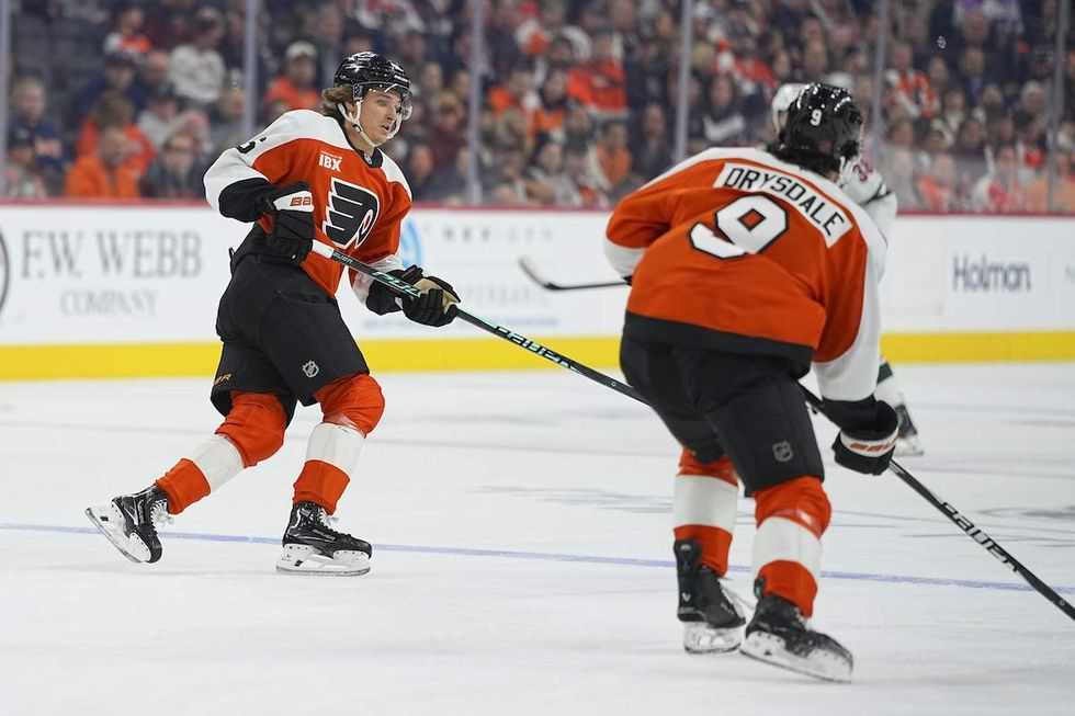 Trevor Zegras #46 and Jamie Drysdale #9 of the Philadelphia Flyers skates against the Minnesota Wild