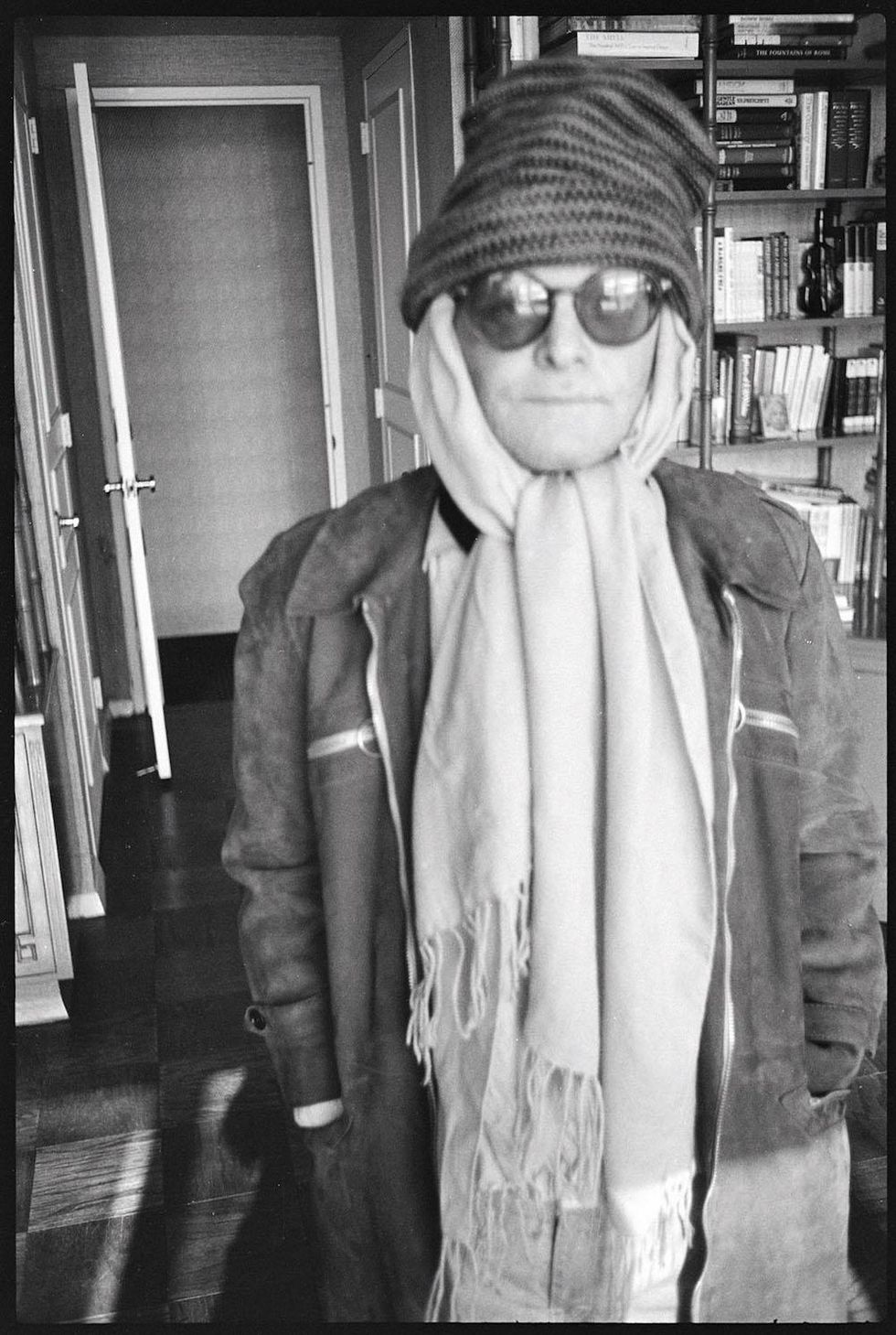 Truman Capote at this apartment in scarf and hat, 1979.