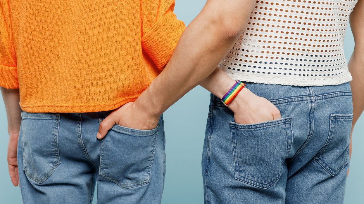 Two gay men with their hands in each other's back pockets