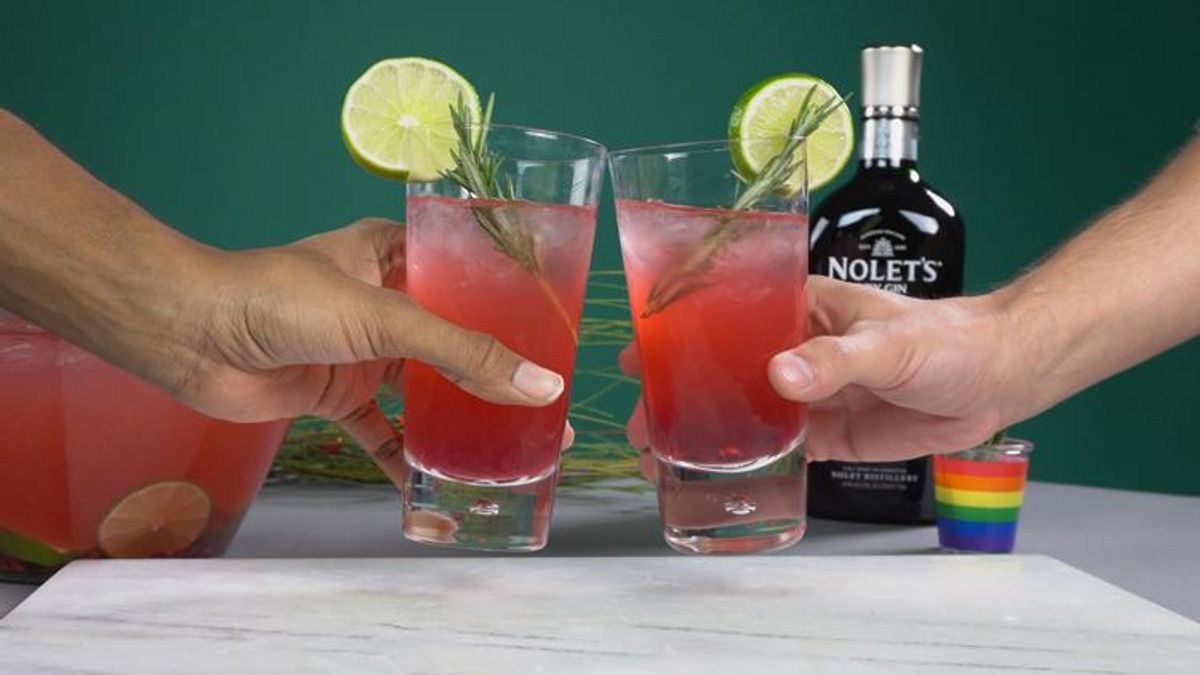 Two hands cheers glasses of NOLET'S Pomegranate Mule Punch.