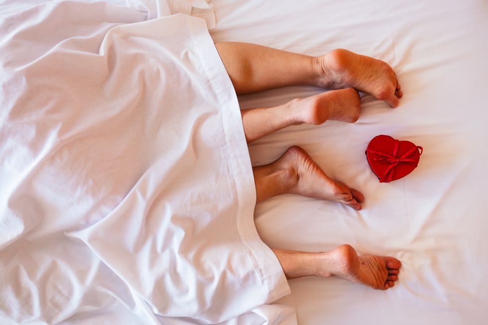 two lesbians' legs sticking out from under the blankets