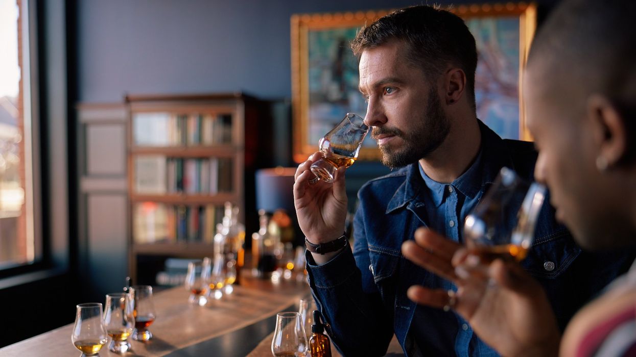 Two men are sipping bourbon at a tasting.