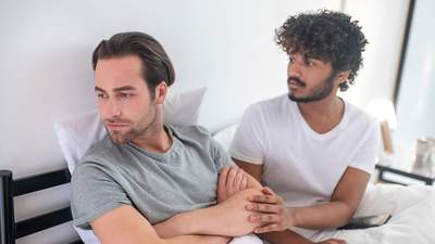 two men in bed