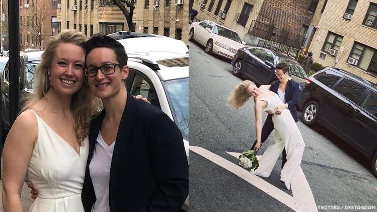 Two women getting married on a sidewalk