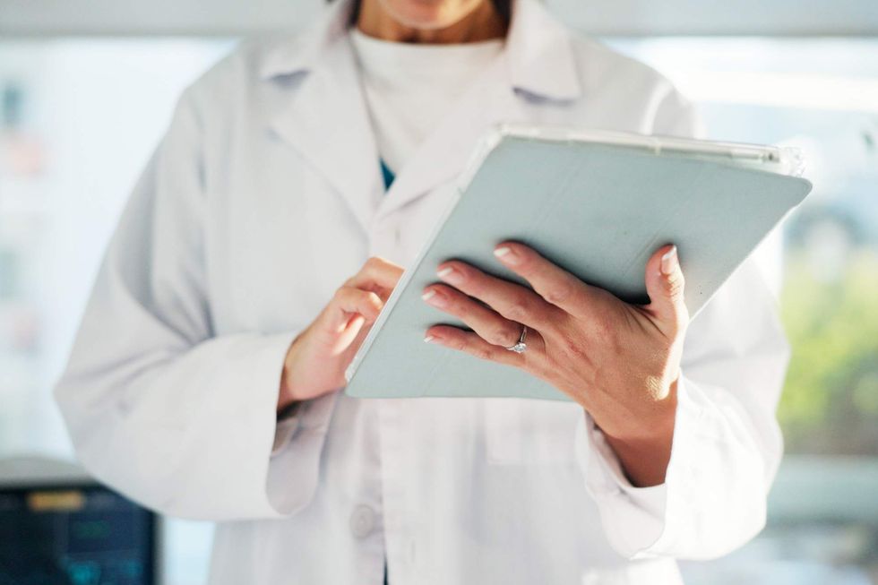 \u200bA doctor holding a clipboard.