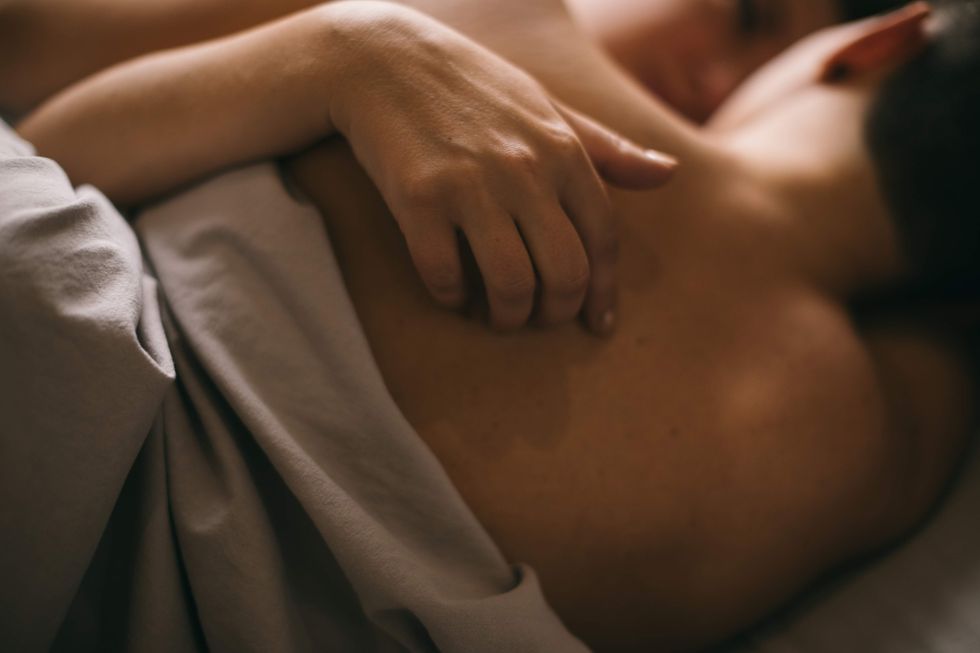 \u200bA lesbian couple cuddling in bed